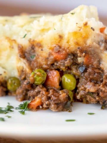 side view of slice of shepherd's pie on a white plate