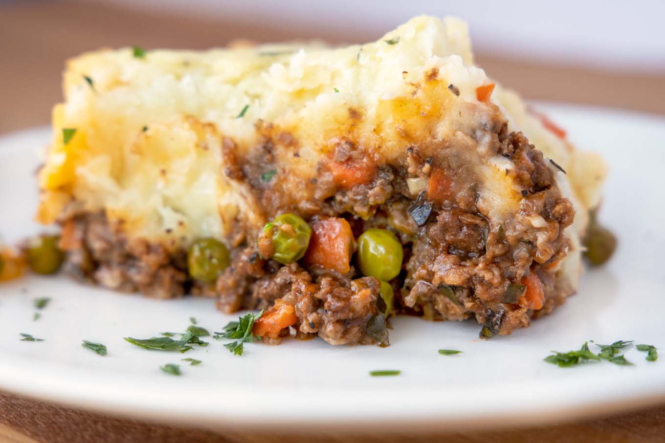side view of slice of shepherd's pie on a white plate