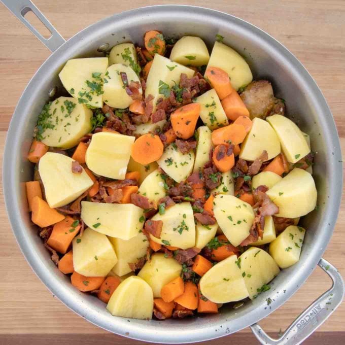 potatoes, carrots and bacon added to the pan and seasoned with salt, pepper, thyme and parsley