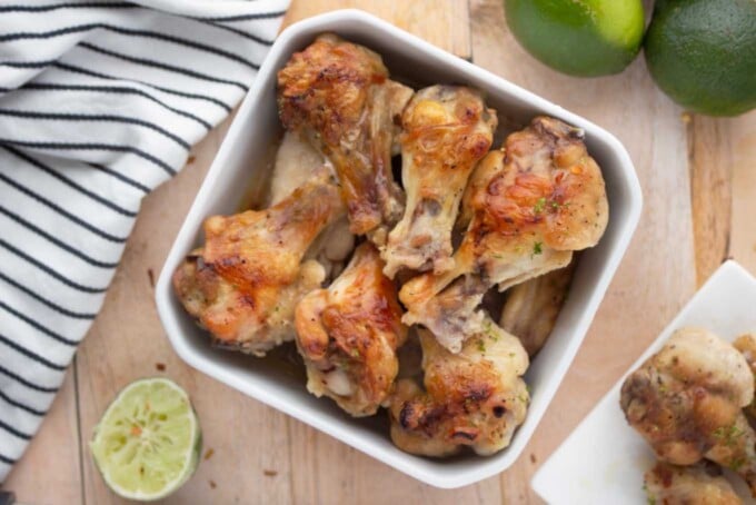 Tequila Lime Drunken Chicken Wings on a white bowl next to a kitchen towel