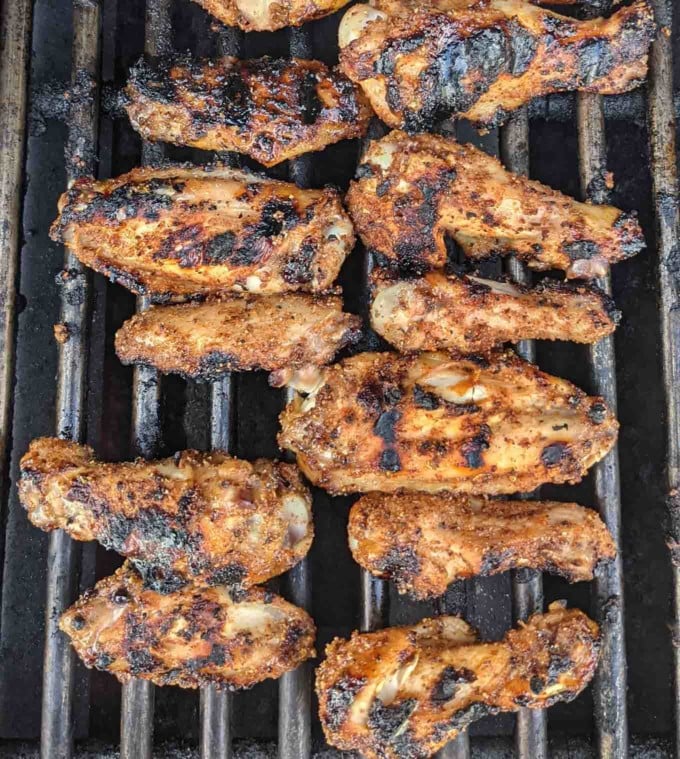 dry rub wings cooking on the grill