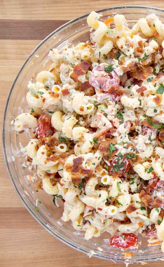 overhead partial view of bowl of Tuna Macaroni Salad Deluxe topped with crispy bacon bits and parsley