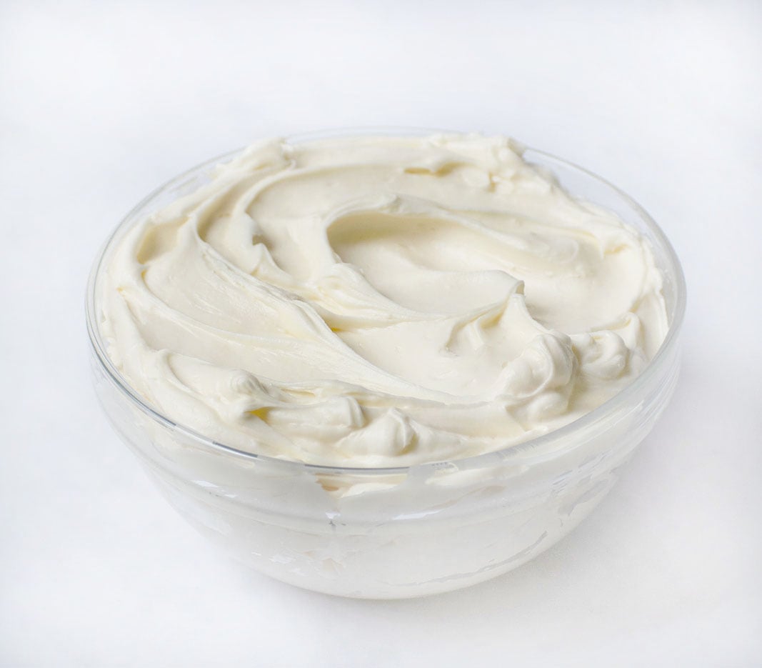 cream cheese frosting in glass bowl