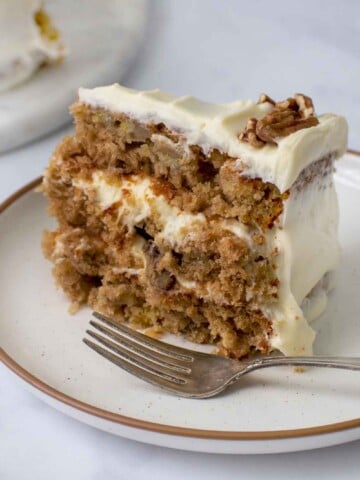 slice of hummingbird cake on a plate with a fork