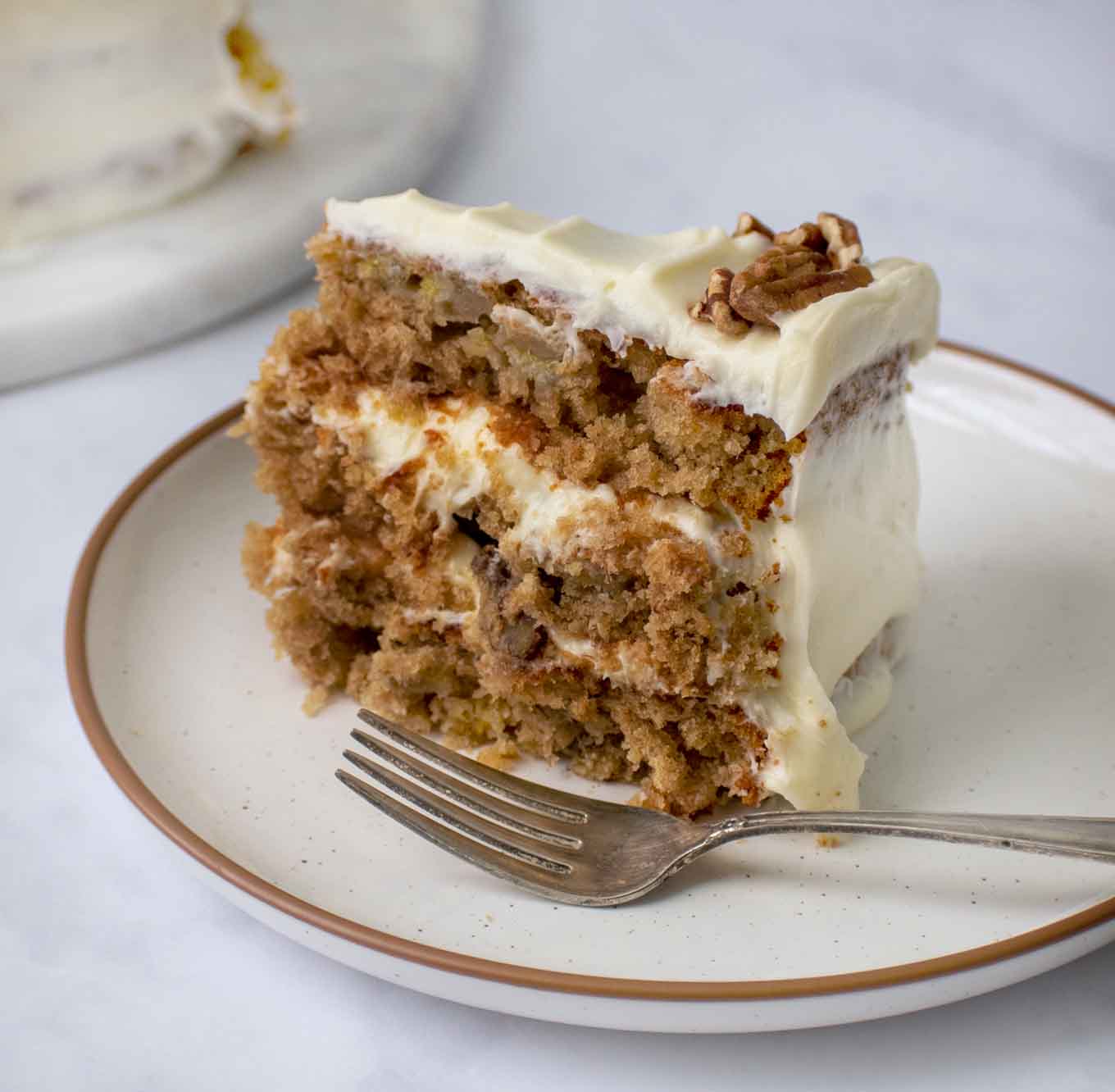 slice of hummingbird cake on a plate with a fork