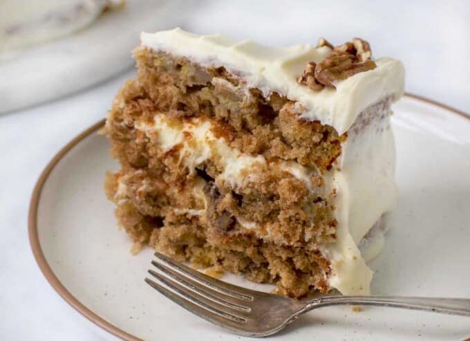 slice of hummingbird cake on a plate with a fork