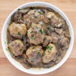 overhead view of chicken marsala meatballs in a white bowl