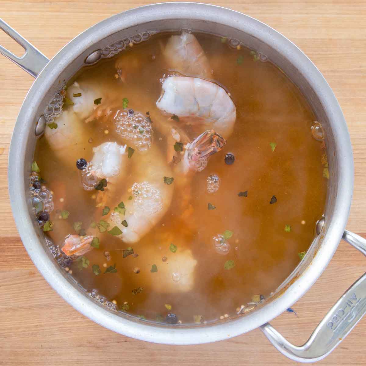 Shrimp added to pot of boiling seasoned water.