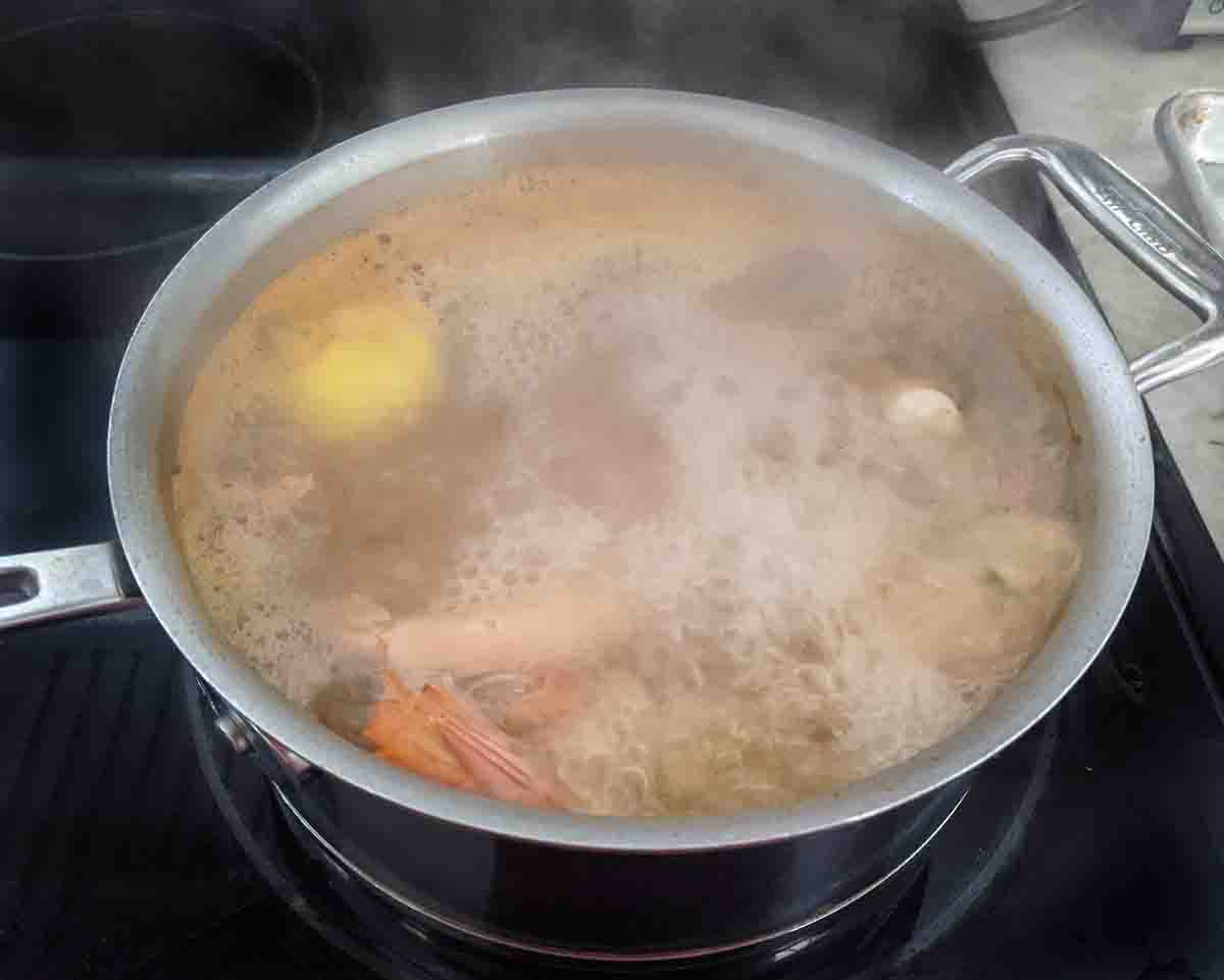 shrimp boiling in a pot on the stove