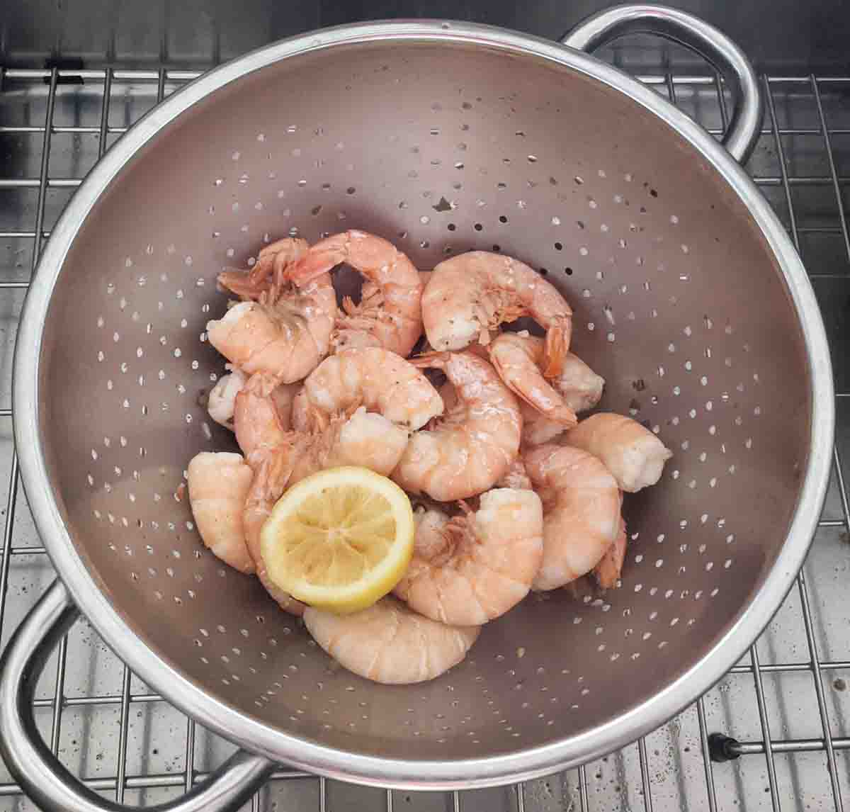 Drained shrimp in strainer.