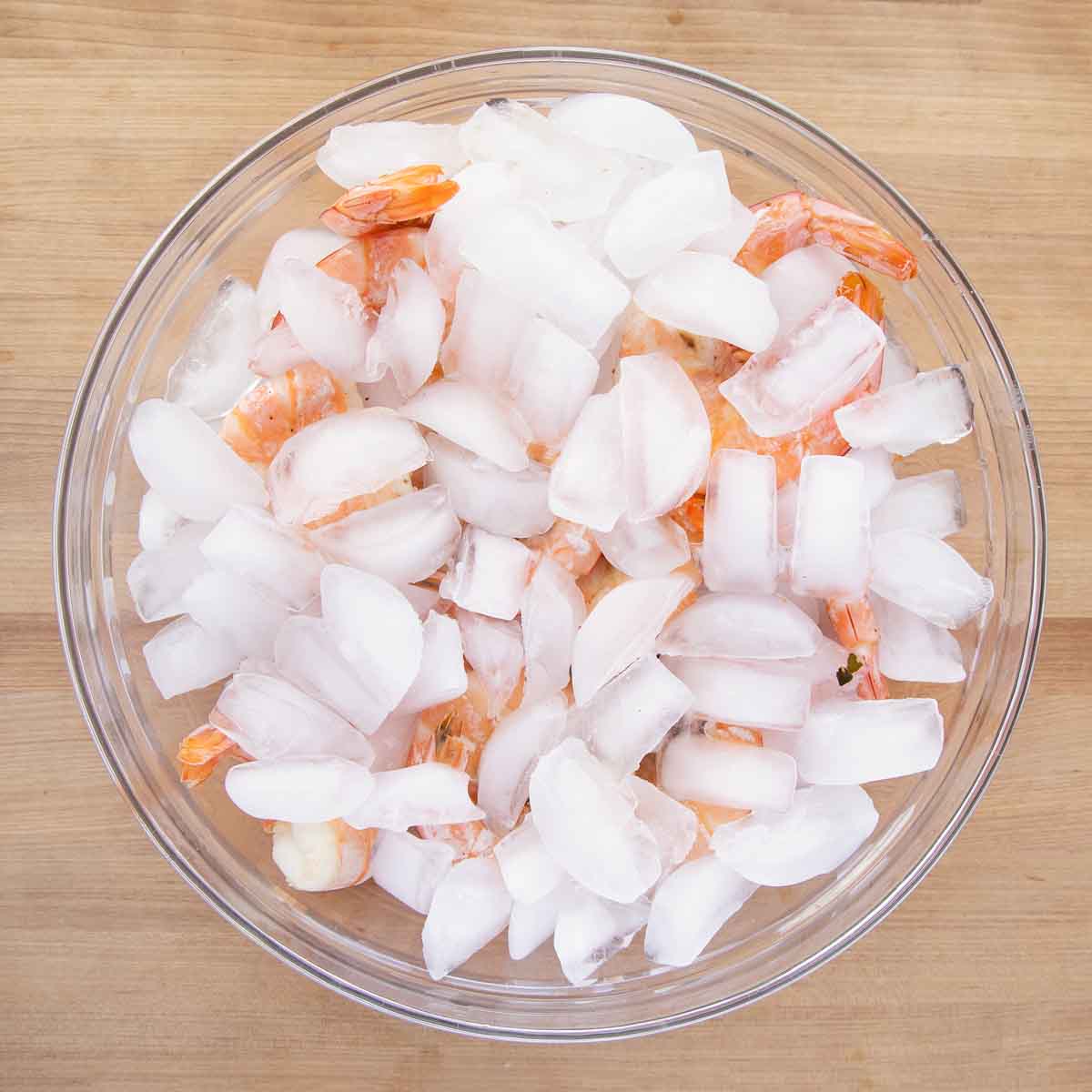 Shrimp and ice in a large bowl.