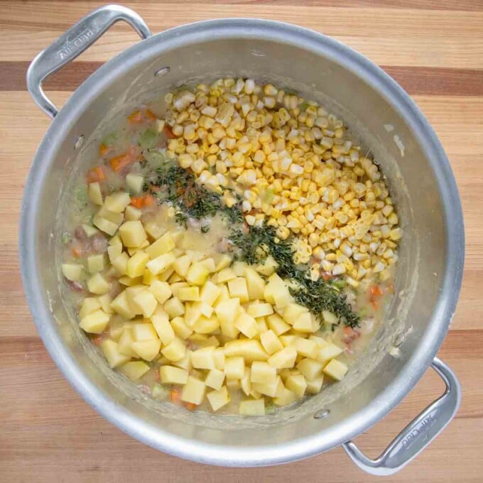 potatoes, corn and fresh thyme added to pot