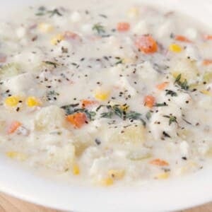 close up of fish chowder in white bowl