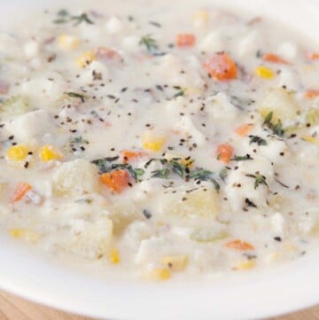 close up of fish chowder in white bowl