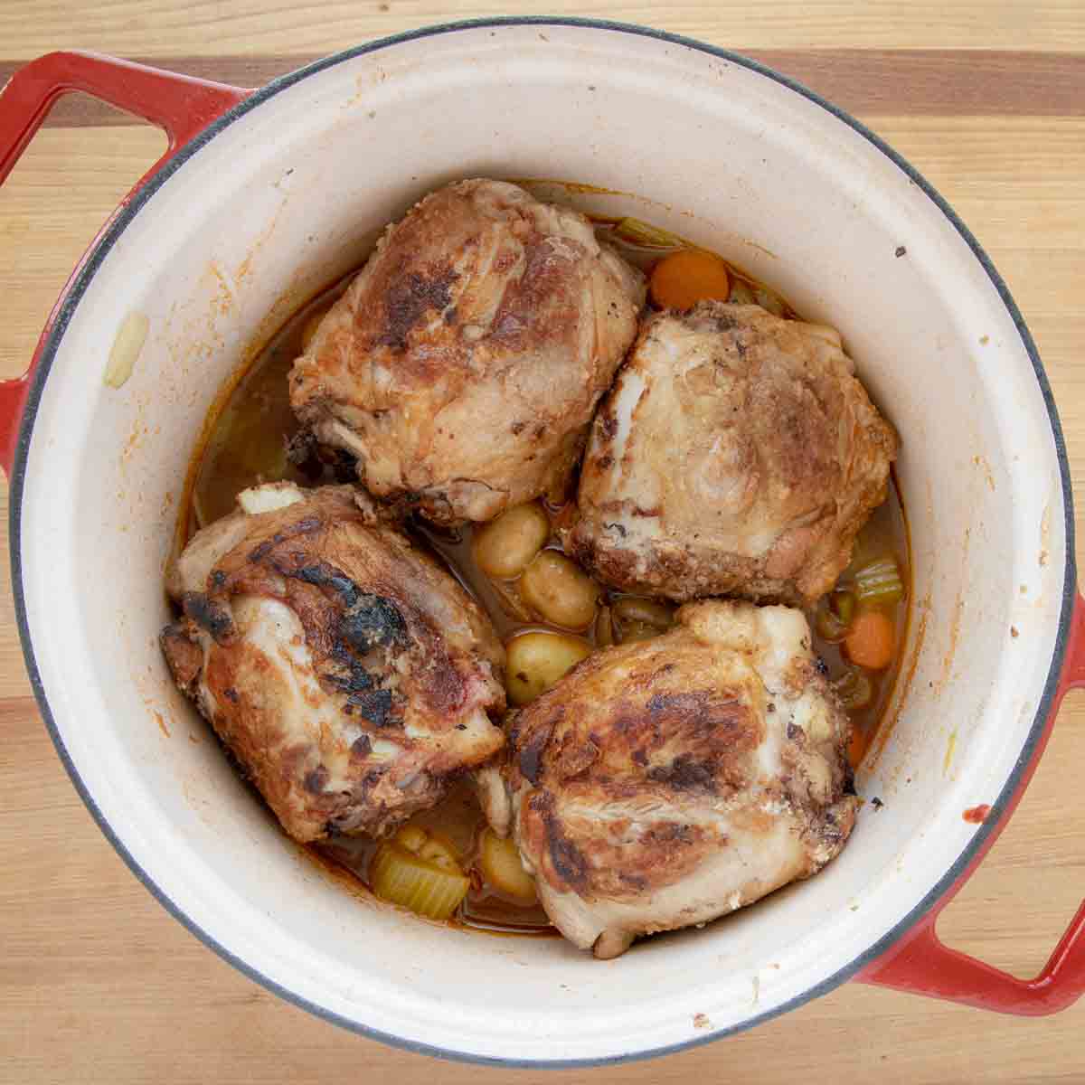 pork shanks added to pot with some of the veggies and stock.