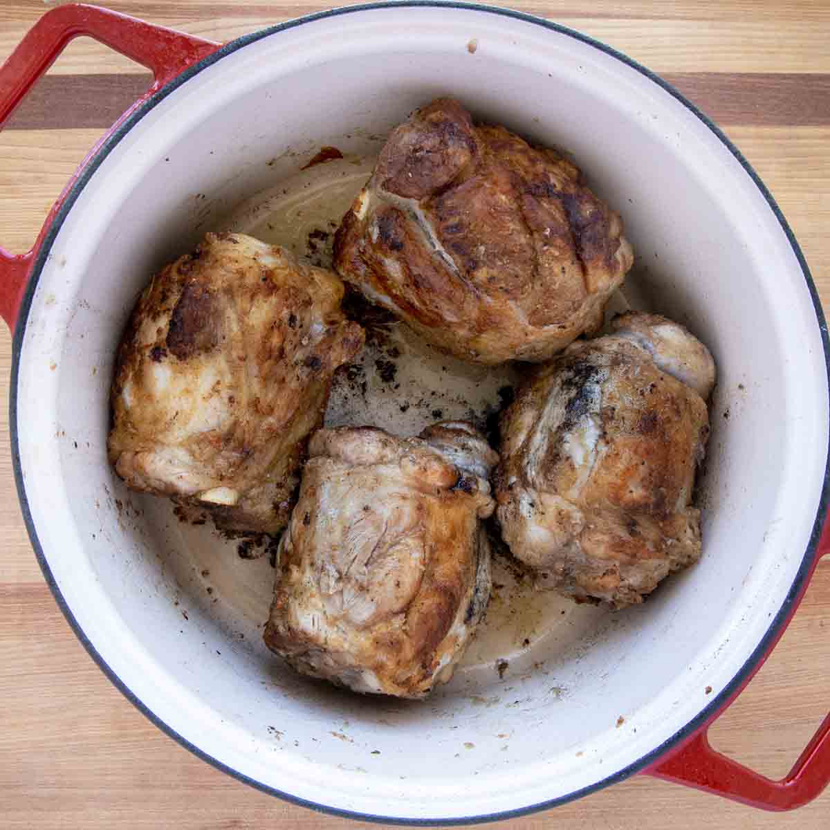 seared pork shanks in a dutch ovenm