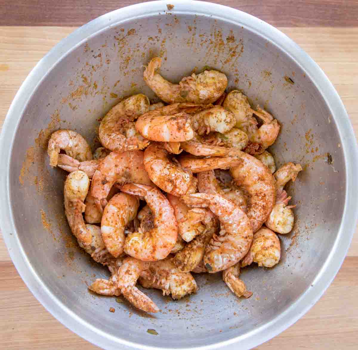 seasoned cooked pell and seat shrimp in a metal bowl