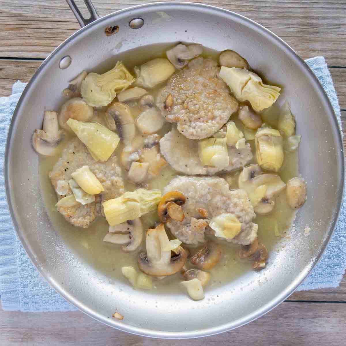 finished veal piccata in the frying pan.