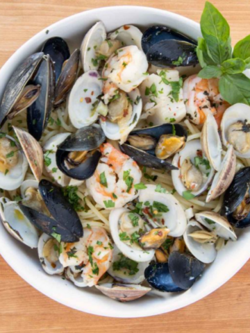 partial view of Frutti di mare in a white bowl