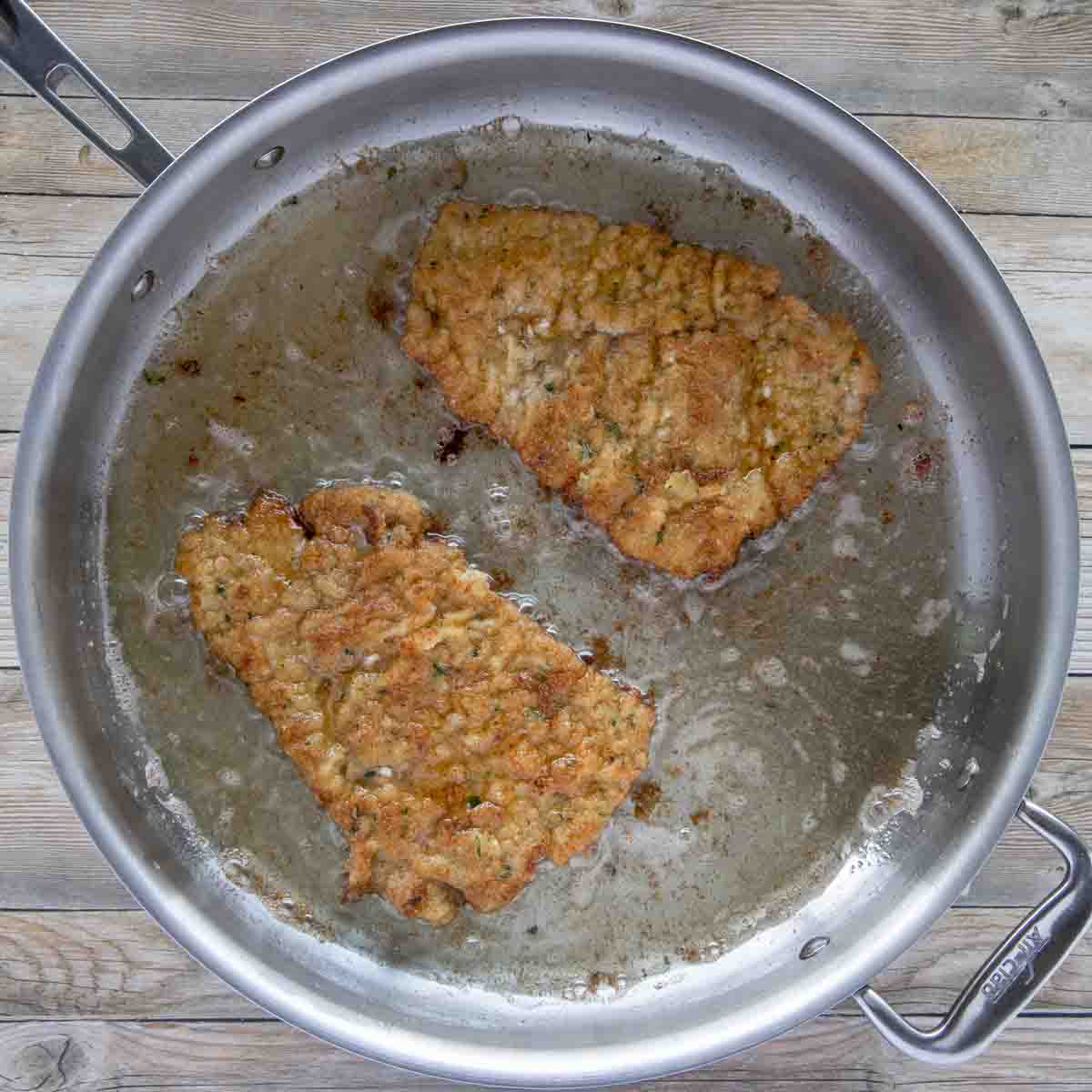 pan frying veal in a large skillet