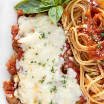 overhead view of veal parm and linguine on a white plate