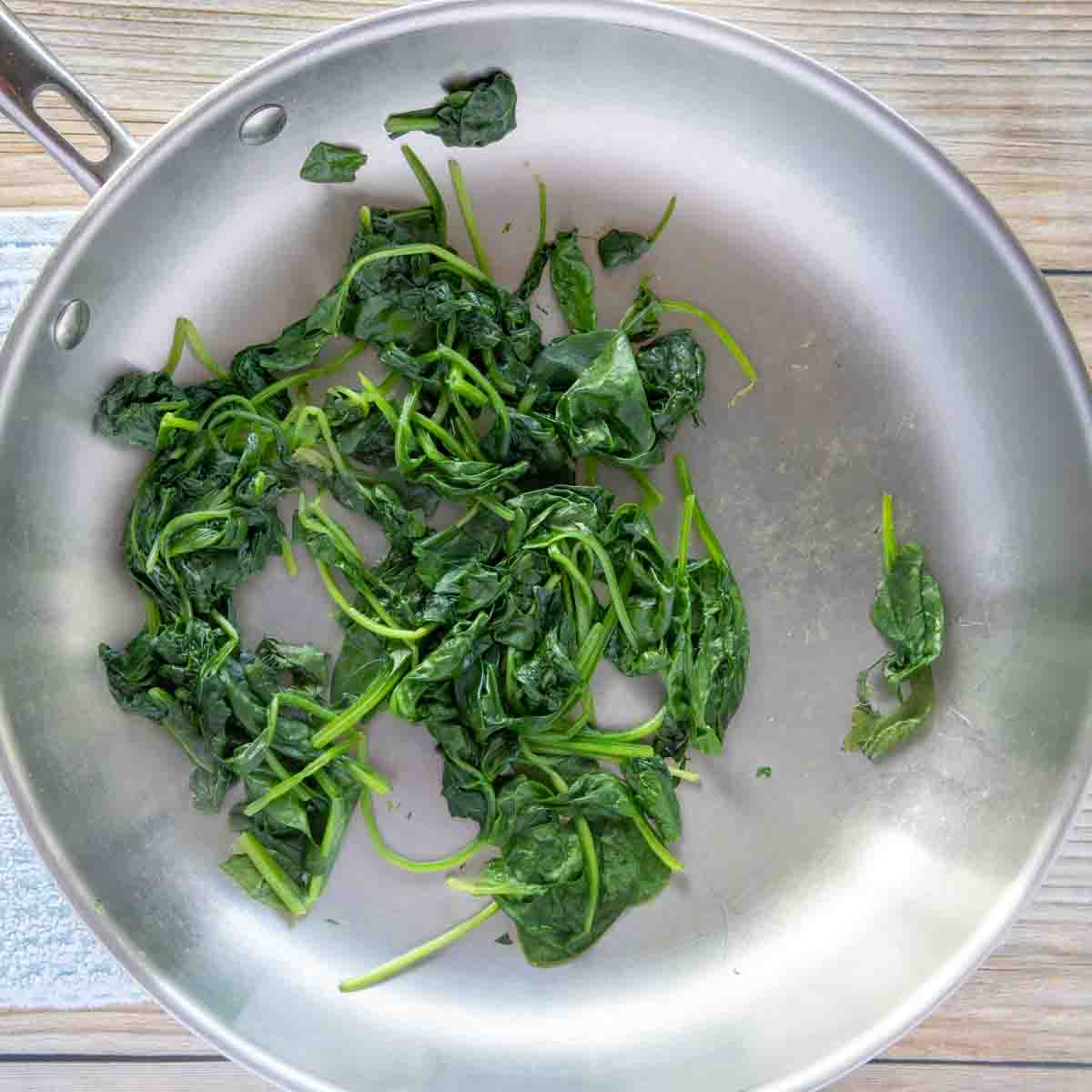 wilted spinach in a saute pan