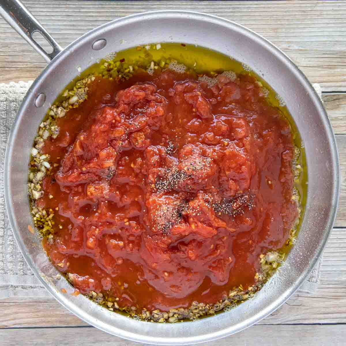 tomatoes and tomato paste added to the pan