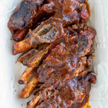 short ribs with sauce on a white platter