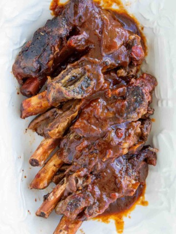 short ribs with sauce on a white platter