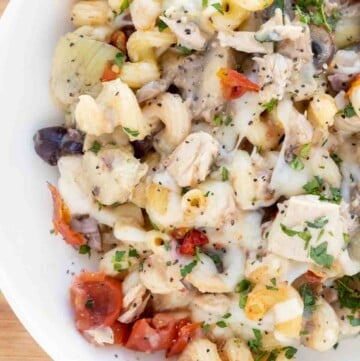 overhead partial view of mediterranean style tuna casserole in a white bowl