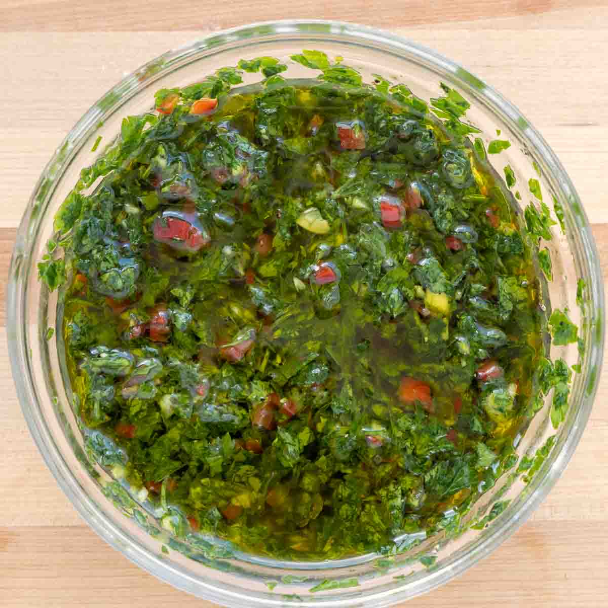 chimichurri sauce in glass bowl.