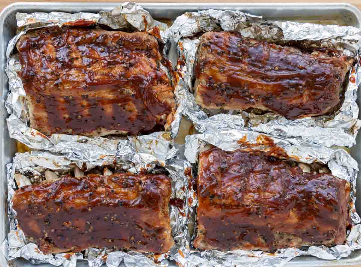 cooked ribs coated with barbecue sauce.