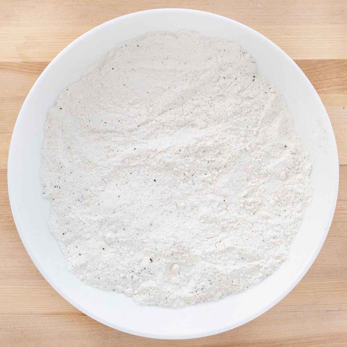 seasoned flour in a white bowl.
