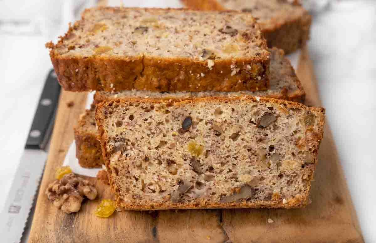 Banana bread sliced on a cutting board.