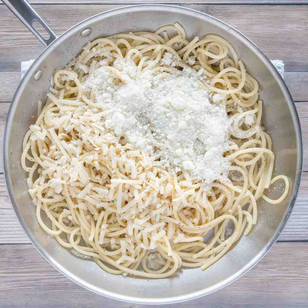 cheese and pasta water added to the skillet with bucatini