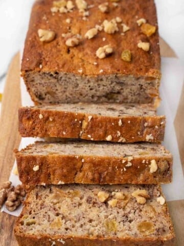 Banana bread sliced on a cutting board.