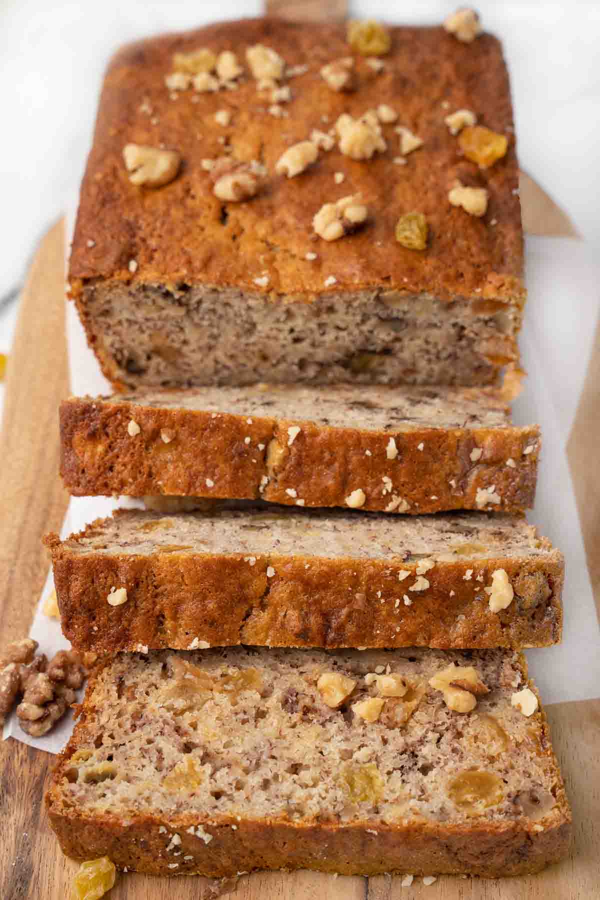 Banana bread sliced on a cutting board.