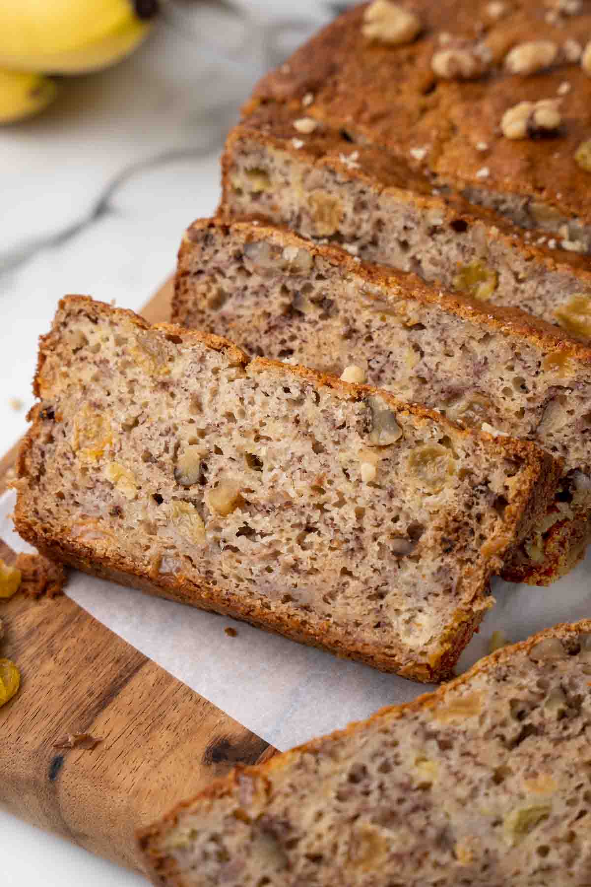 Banana bread sliced on a cutting board.