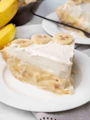 slice of banana cream pie on a white plate