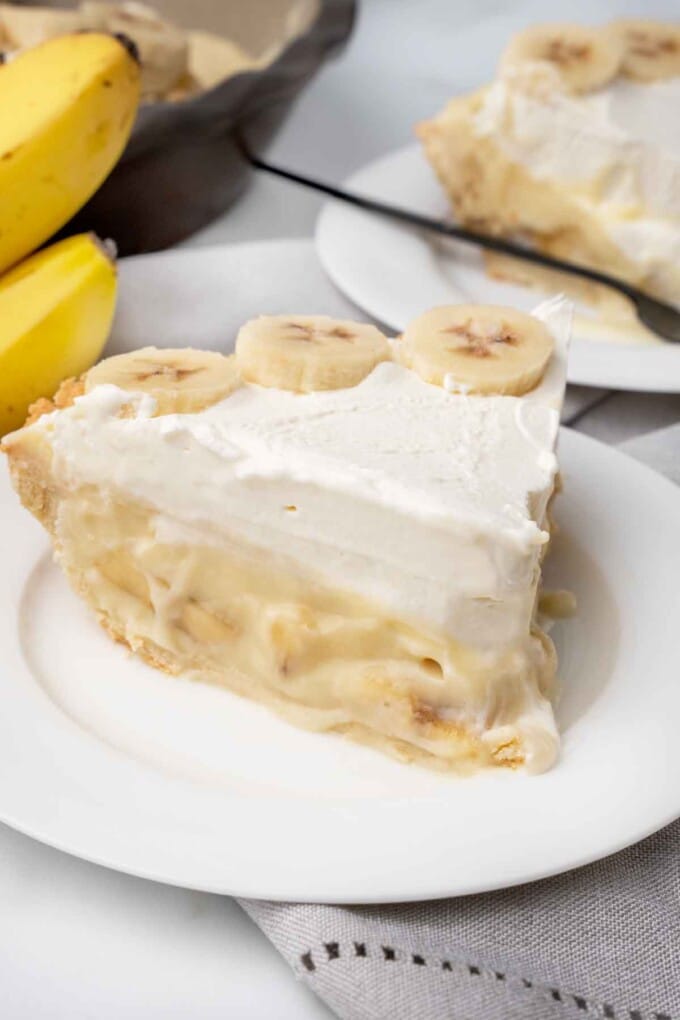 slice of banana cream pie on a white plate