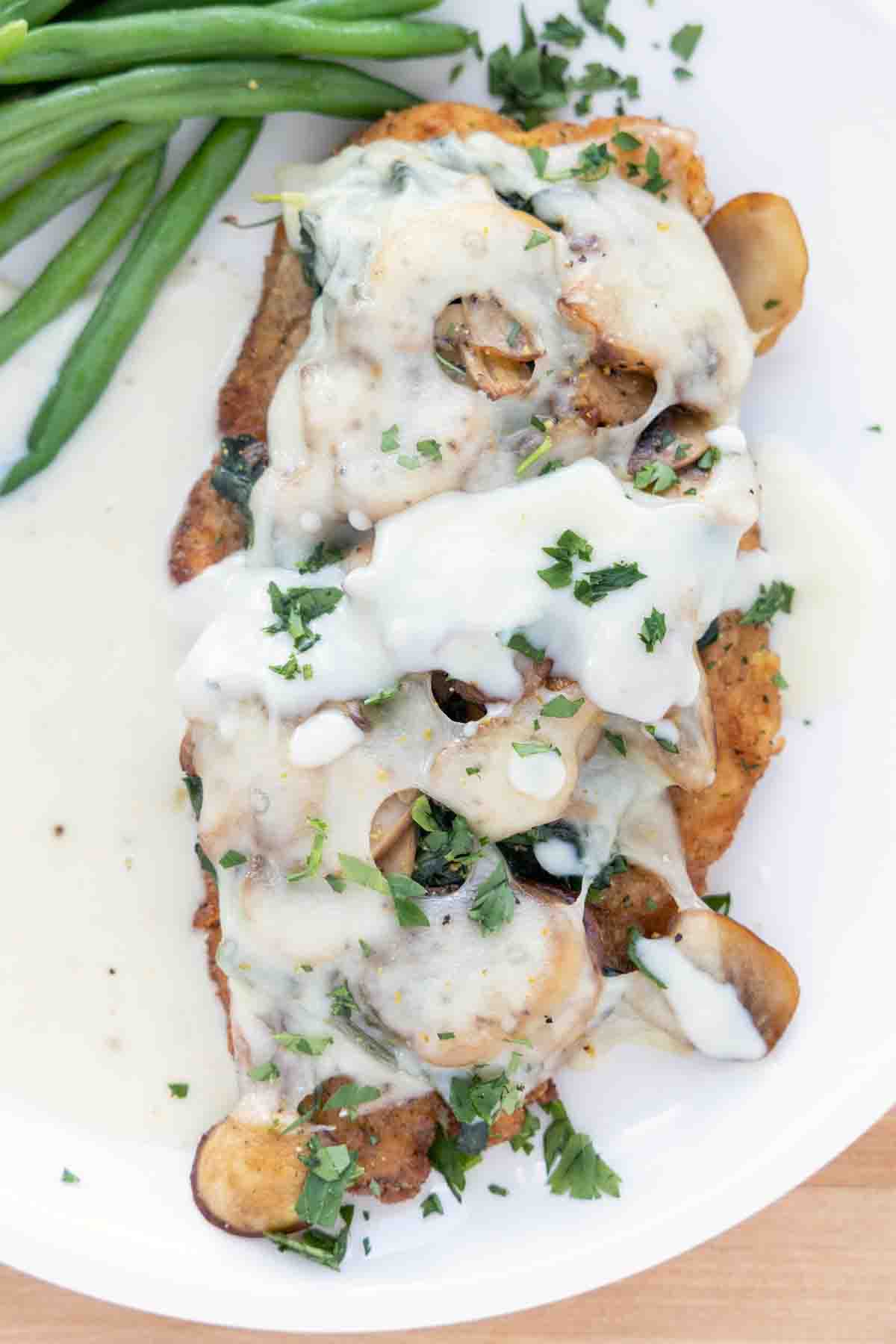 chicken florentine with supreme sauce on a white plate