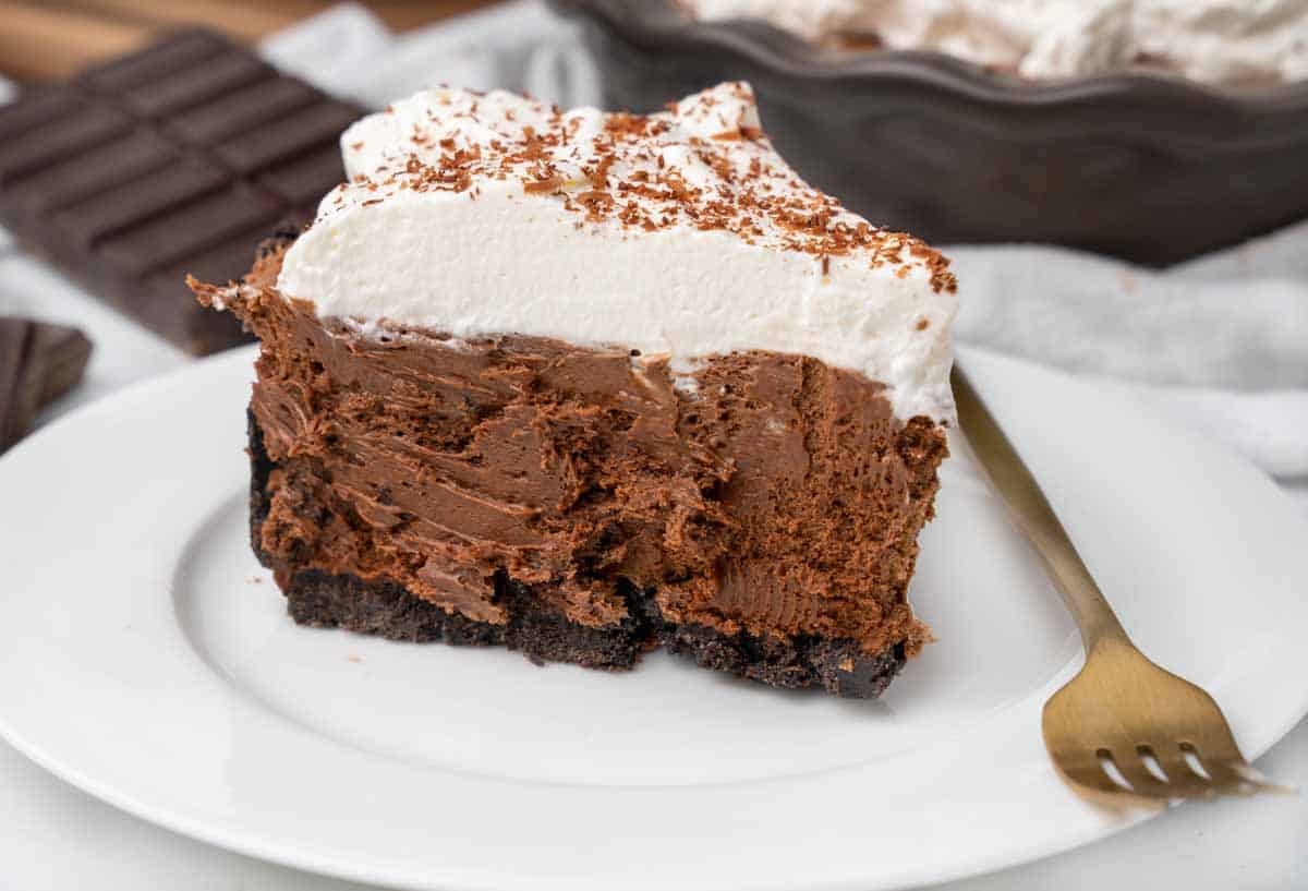 slice of chocolate silk pie on a white plate with a fork