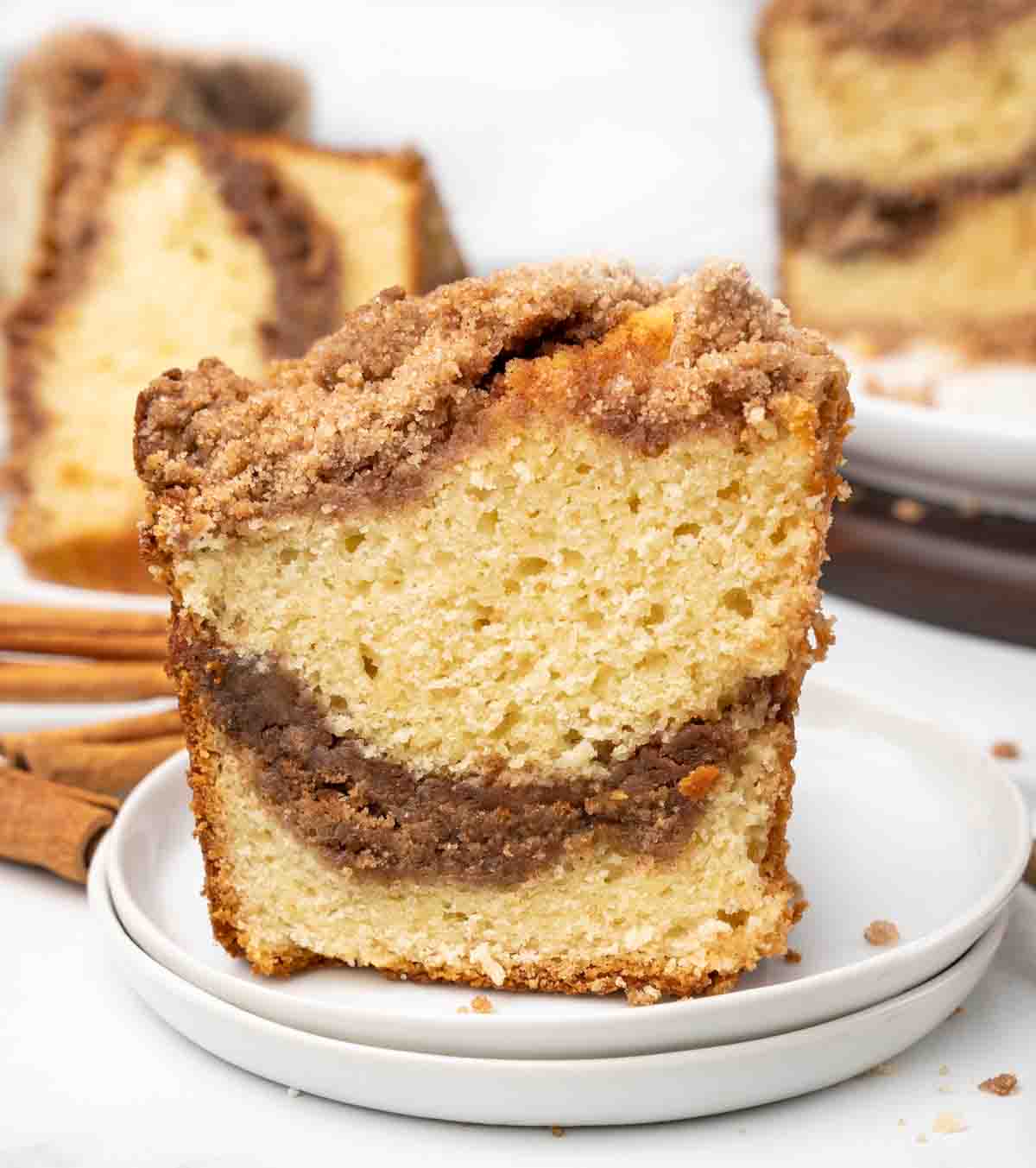 slice of cinnamon streusel coffee cake on a white plate