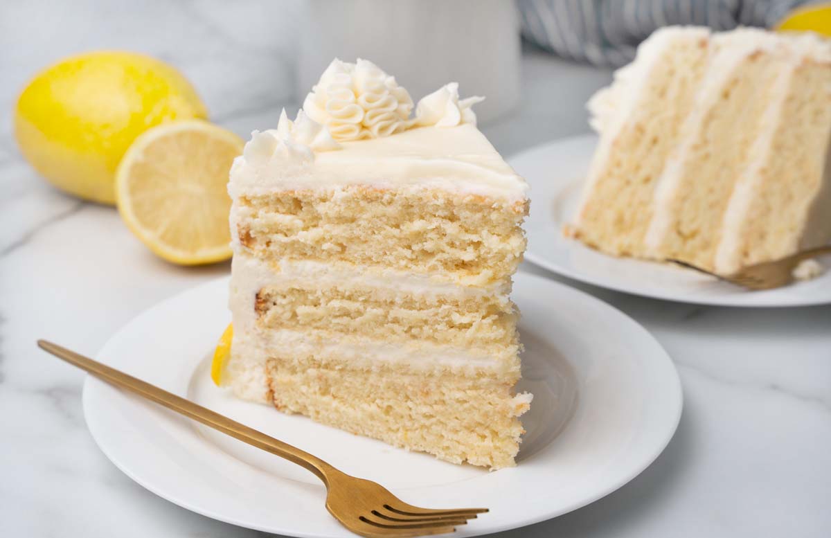 slice of lemon buttermilk cake on white plate with fork