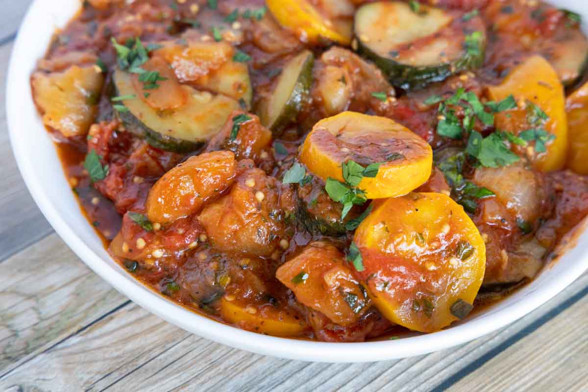 close up view of ratatouille in a white bowl