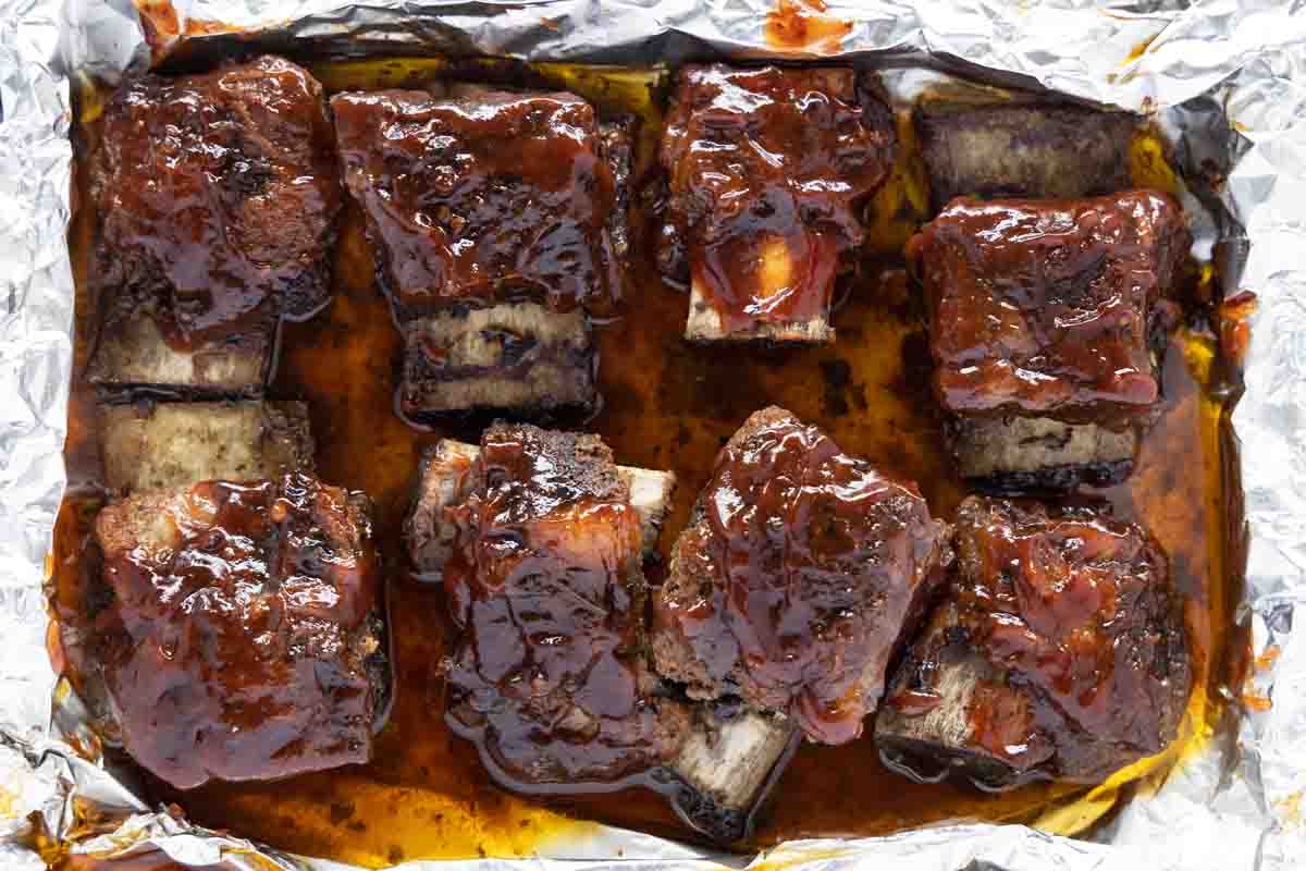 cook ribs with barbecue sauce brushed on