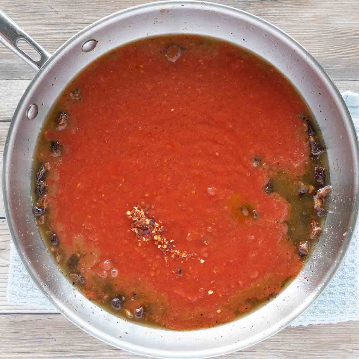 tomatoes added to pan with cooked guanciale