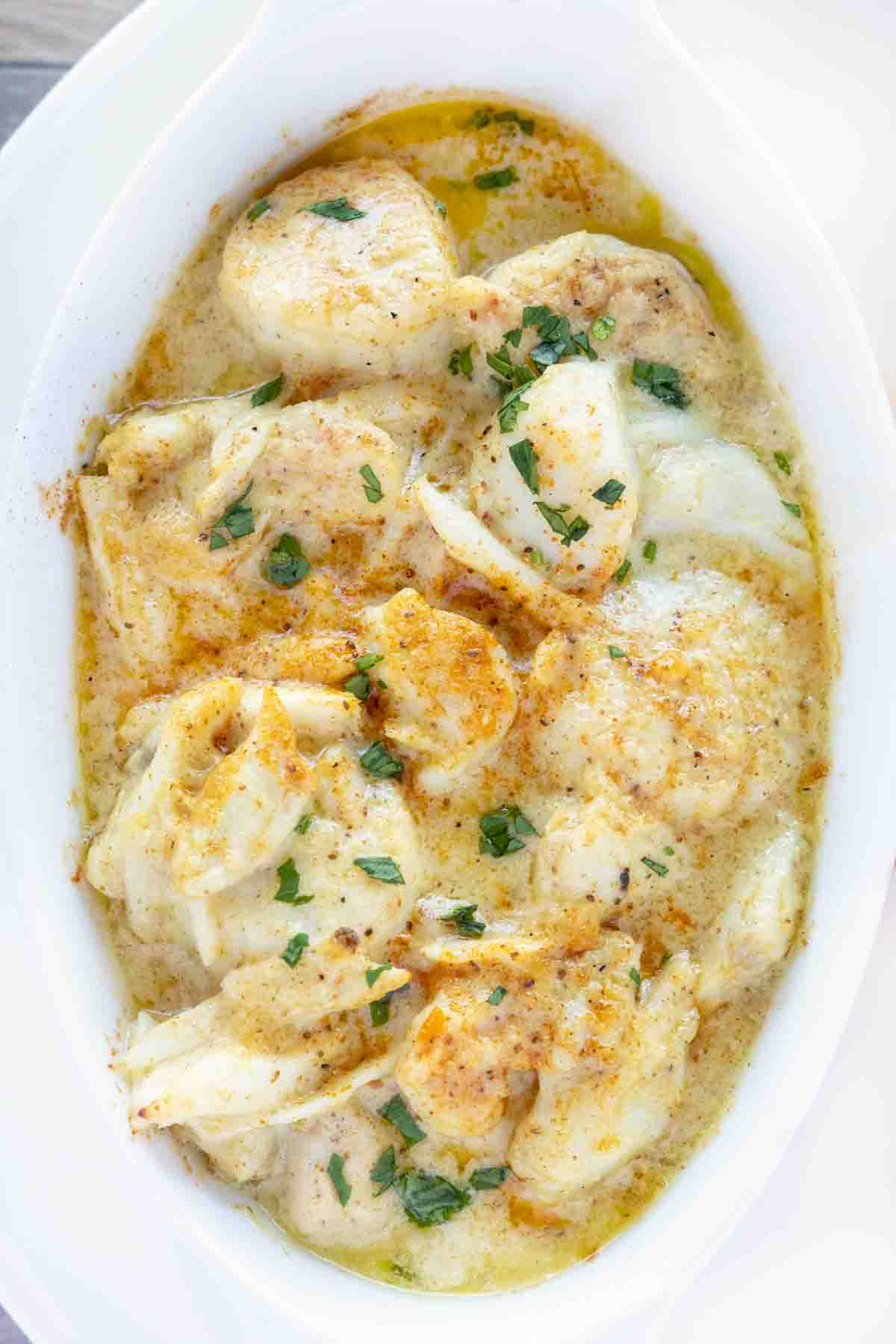 overhead view of baked seafood casserole in a white casserole dish