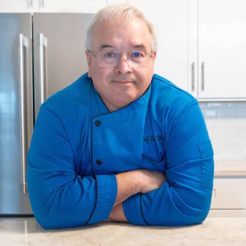 chef dennis in a blue coat