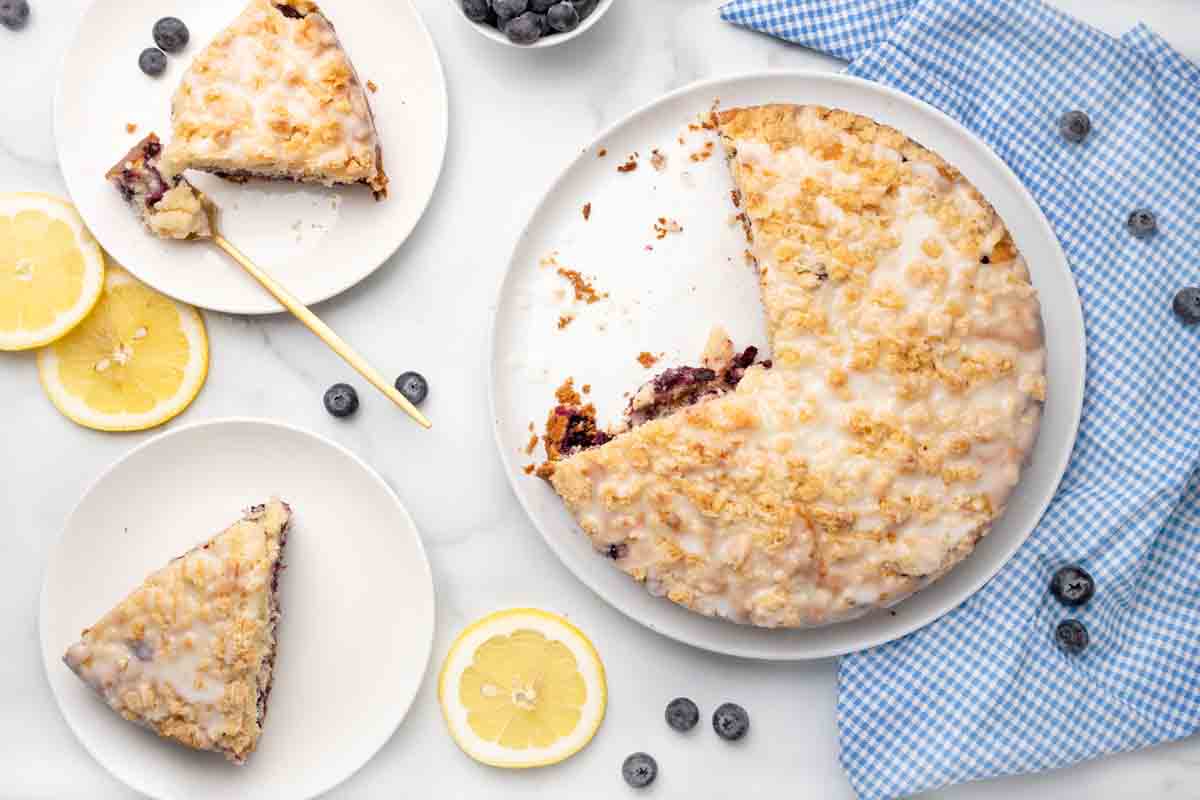 blueberry coffee cake with slices on white plates